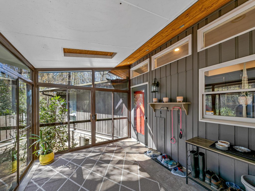 Enter this Pisgah Forest home through the sunroom