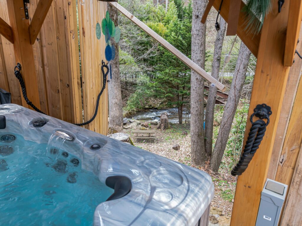 hot tub and creek at Maggie Valley home for sale 