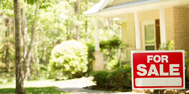 for sale sign in front yard